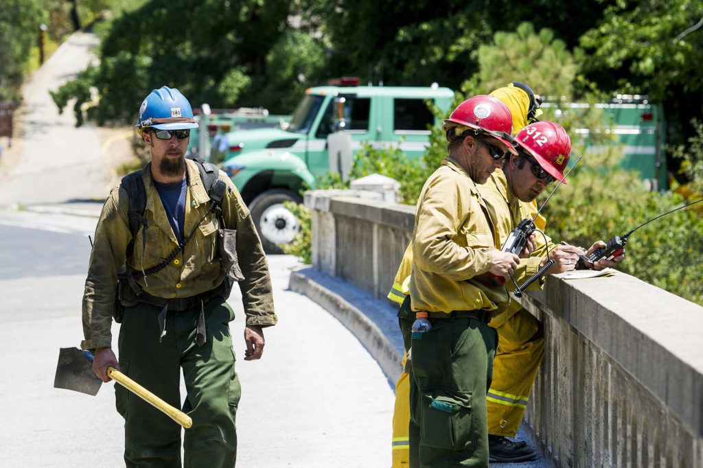 Photo of firefighters on Merced River bridge