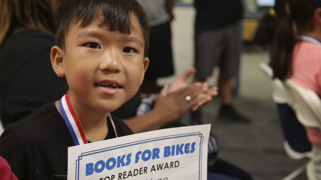 Johnny Yang holds his Top Reader award