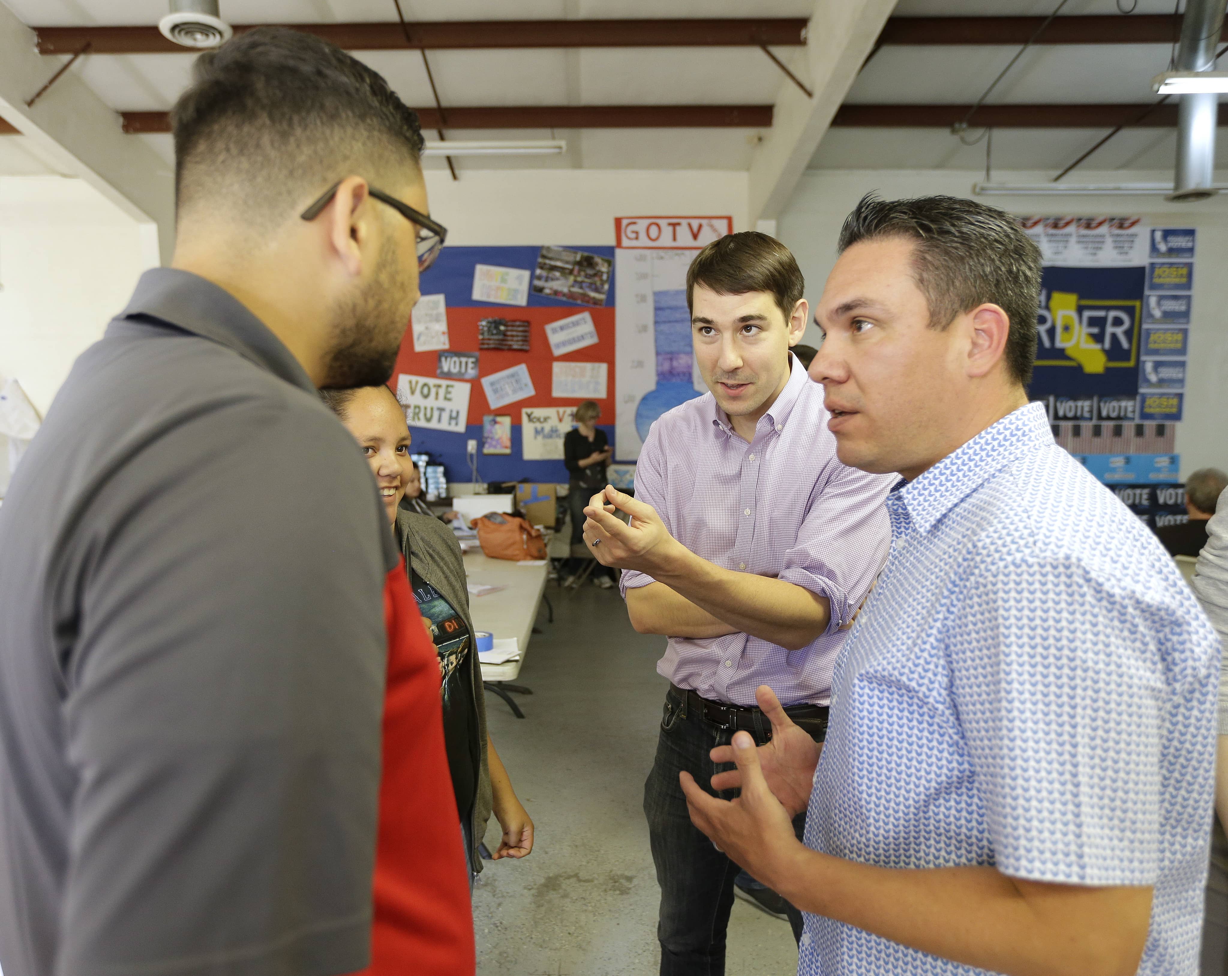 Photo of Josh Harder talking with supporters