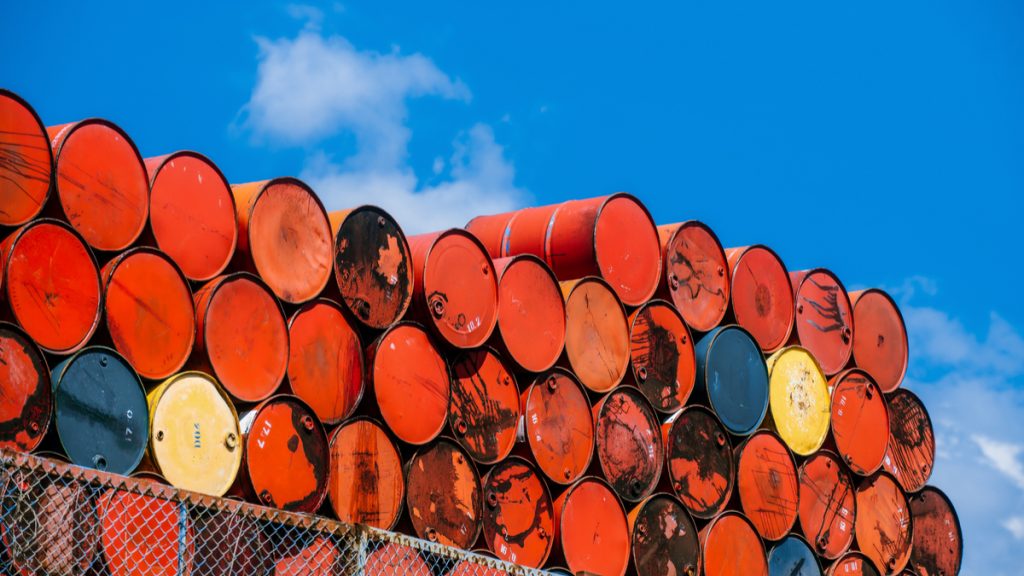 photo of stacked up empty oil barrels