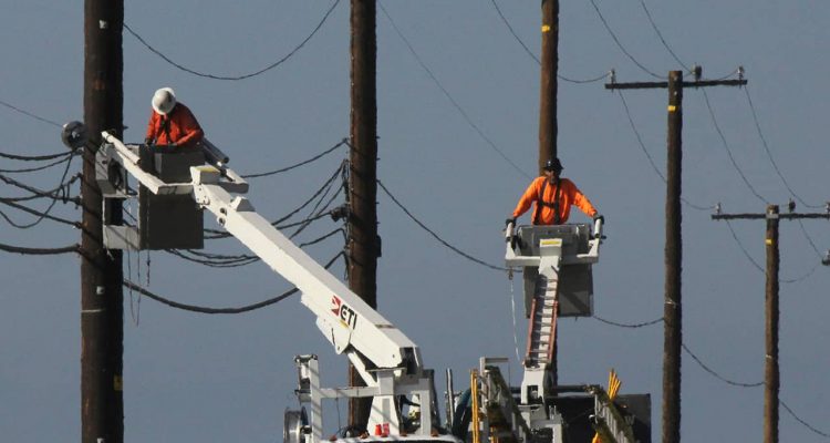 Photo of utility crews repairing overhead lines along the PCH