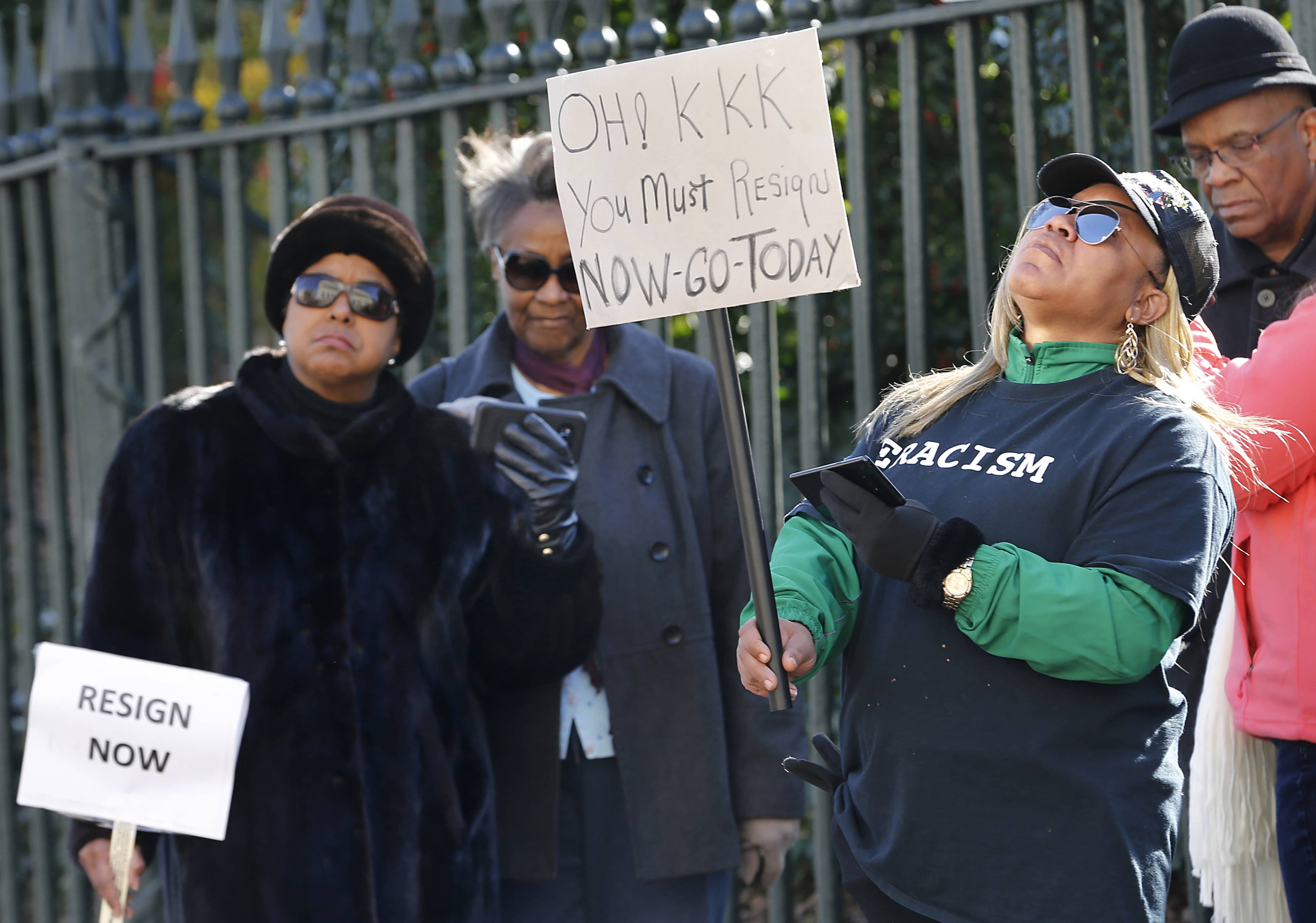 Photo of protesters during a news conference
