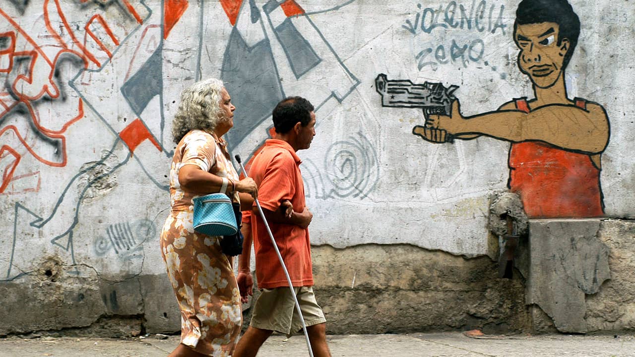 Photo of people walking past graffiti in Brazil