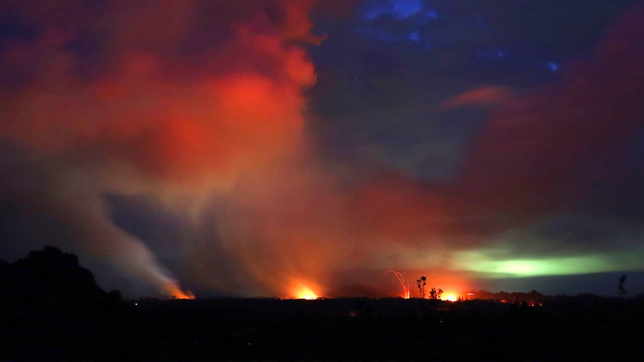 Photo of lava shooting into the night sky in Pahoa, HI
