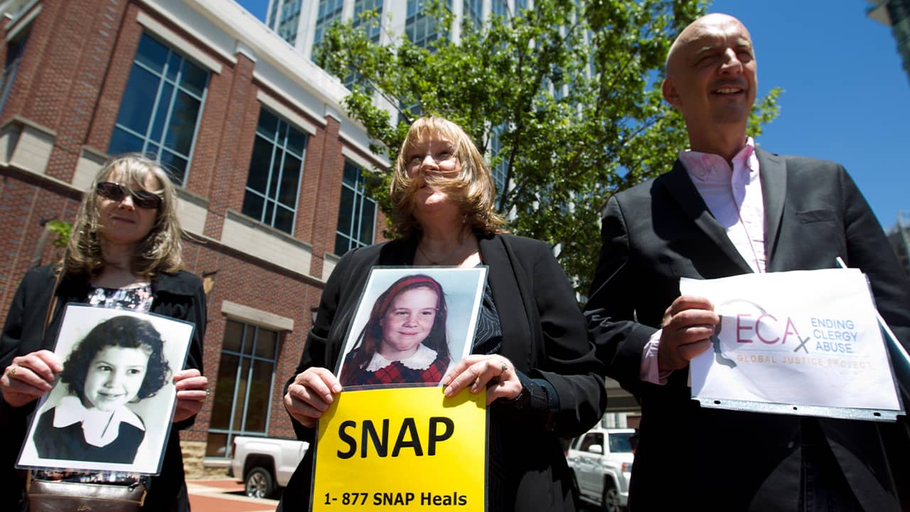 Photo of Becky Ianni, a victim of priest abuse, and other protestors