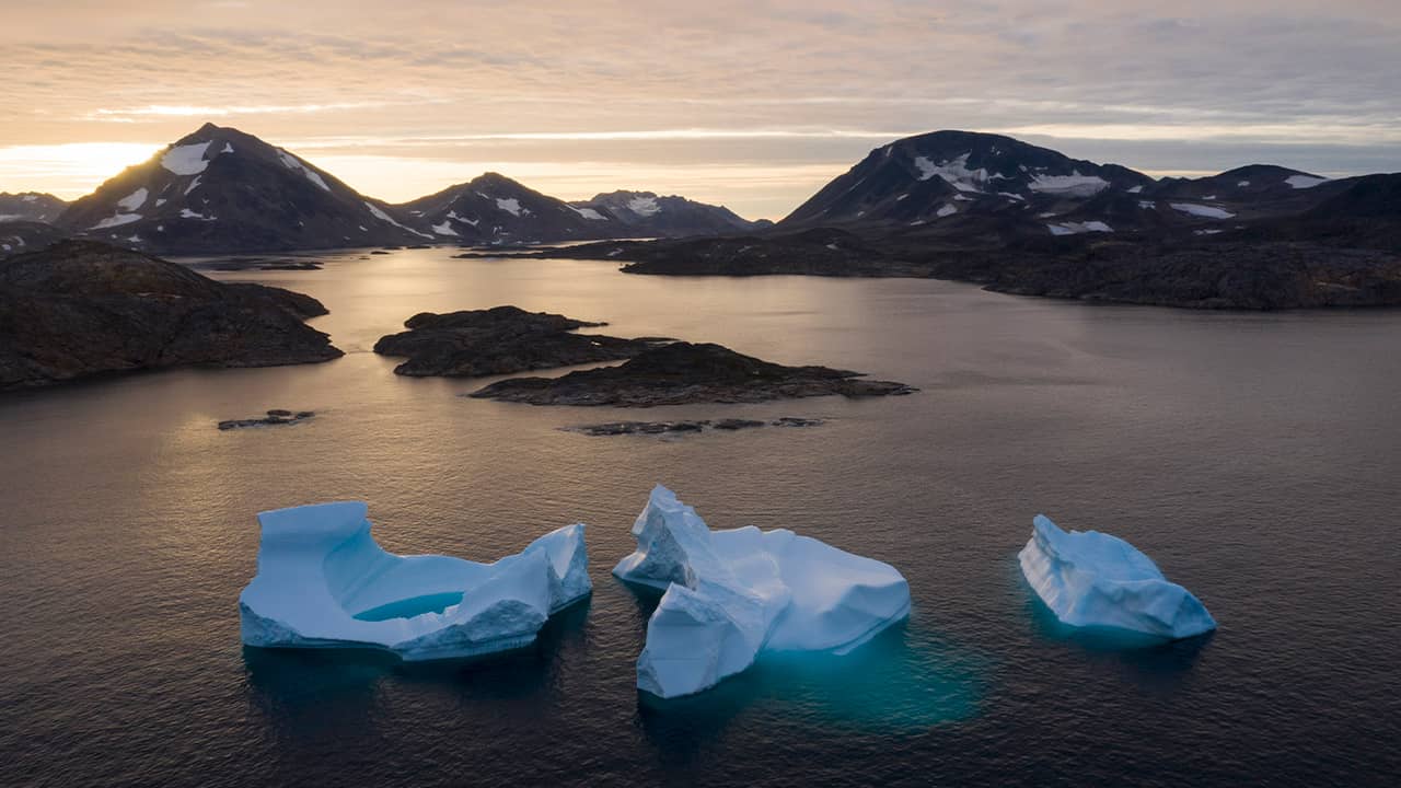 Photo of large icebergs floating in Greenland