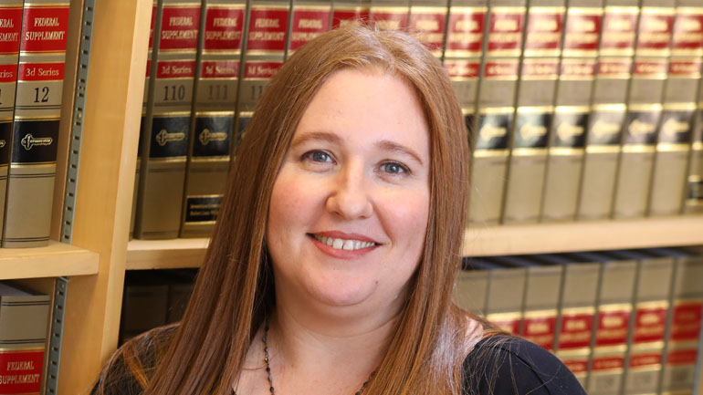 Photo of Jodie Howard in a law library