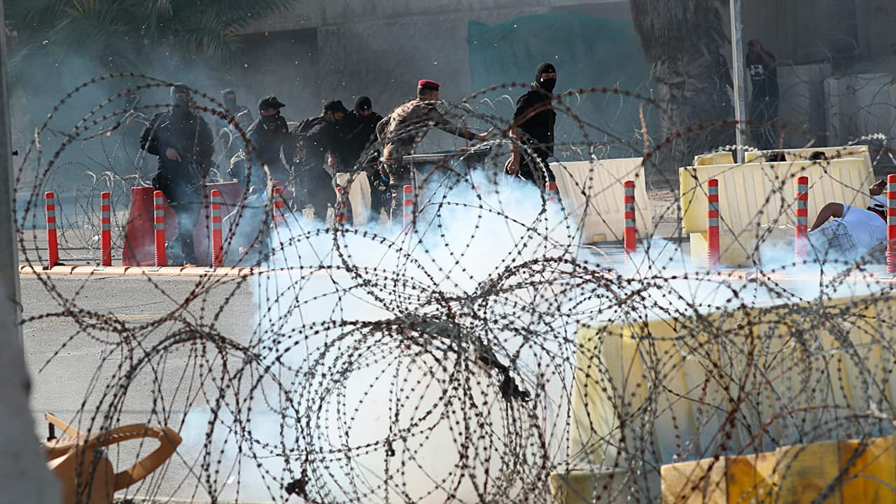 Photo of Iraqi security forces firing tear gas