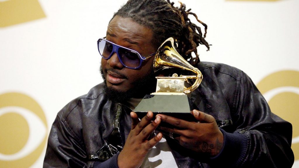 Photo of T-Pain holding his Grammy award