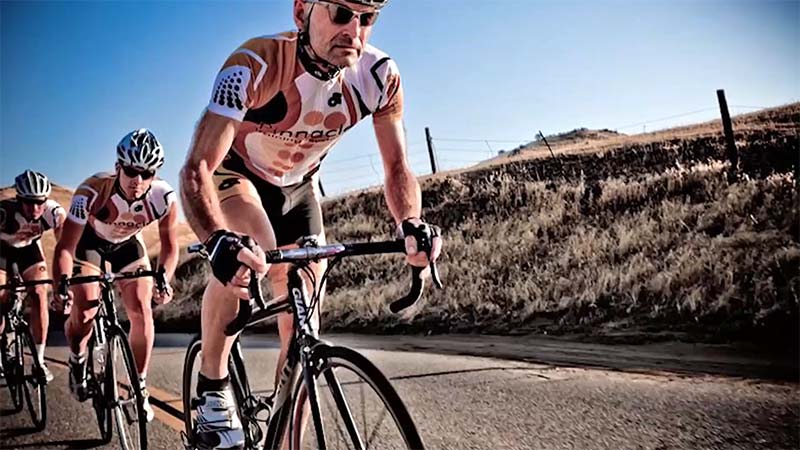 Photo of Ed Lund leading a pack of cyclists