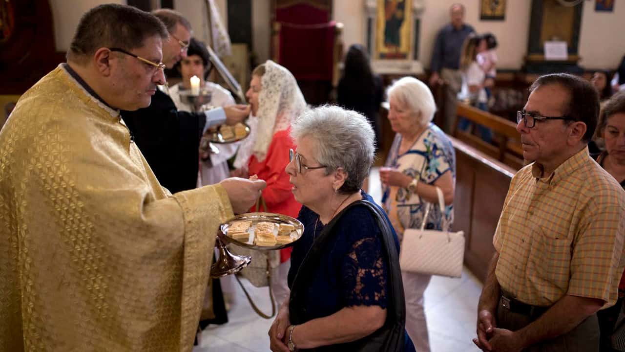 Photo of people partaking in communion at church