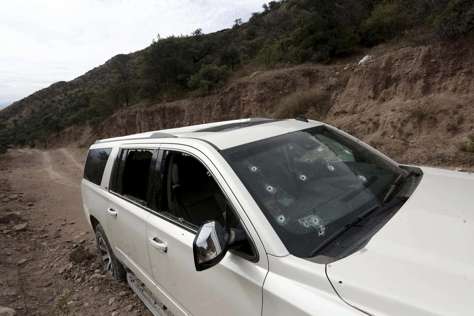 Photo of a car with bullet holes in the windshield