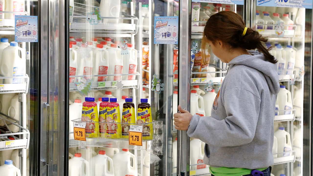 Photo of a woman shopping for milk