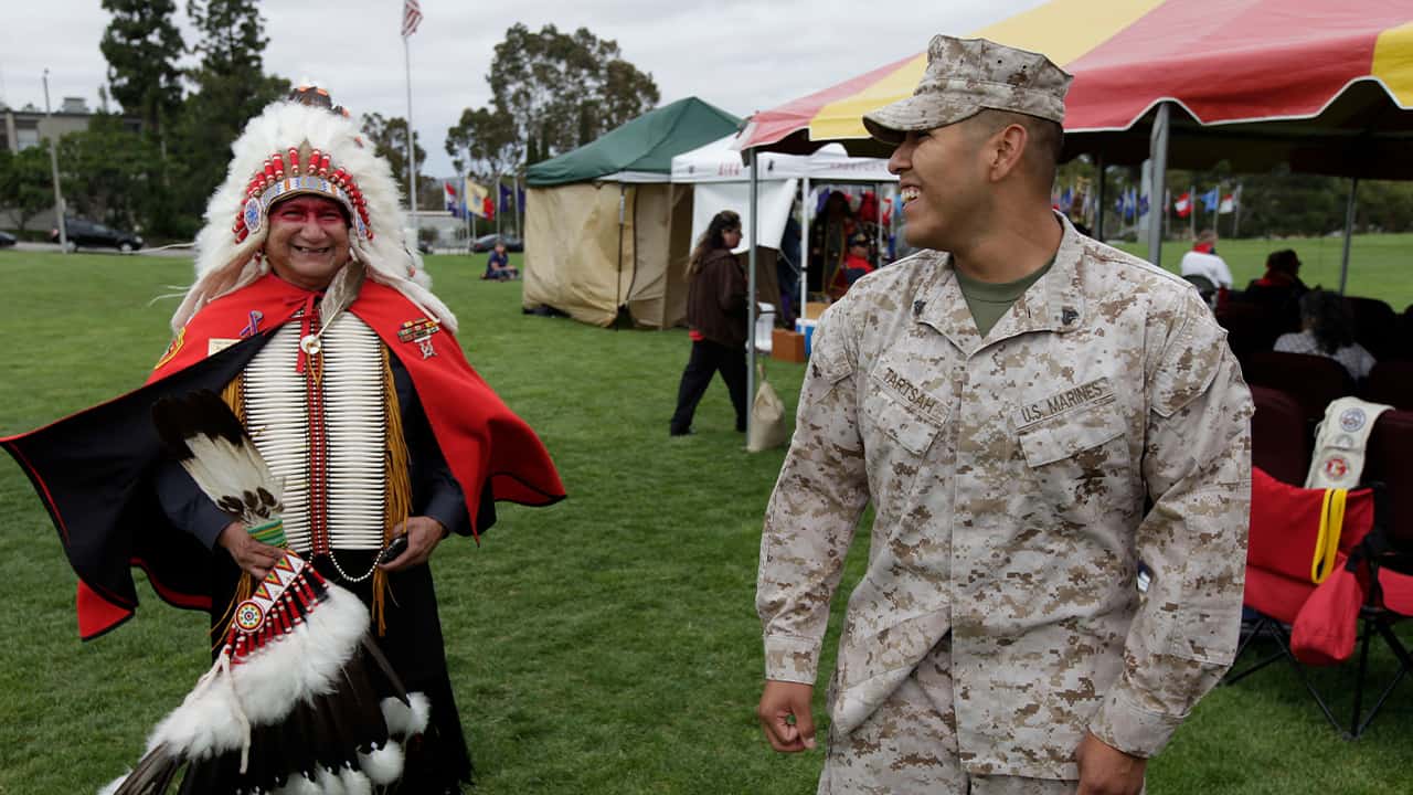 Photo of a Vietnam War veteran talking with Marine Cpl. Frank Tartsah