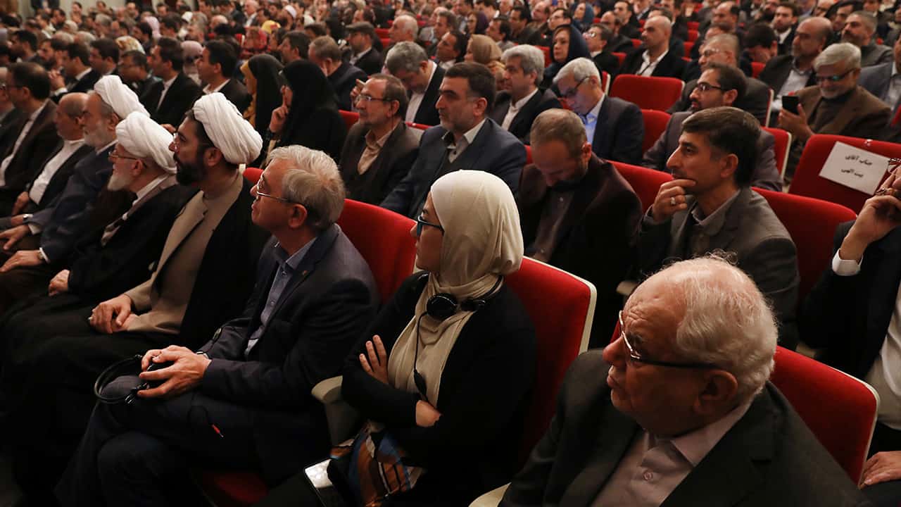 Photo of participants listening to a speaker