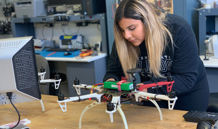 Photo of Samantha Saucedo working on a drone