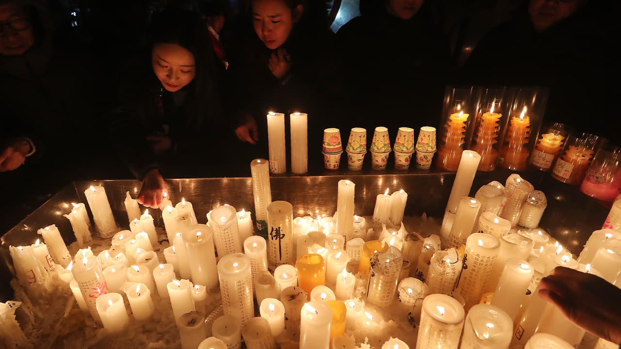 People lighting candles for New Year's in South Korea