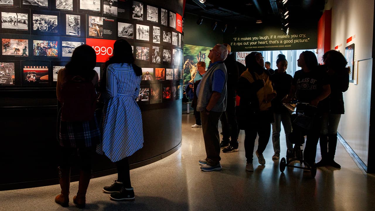 Photo of people visiting the Pulitzer Prize Photography exhibition at the Newseum, in Washington