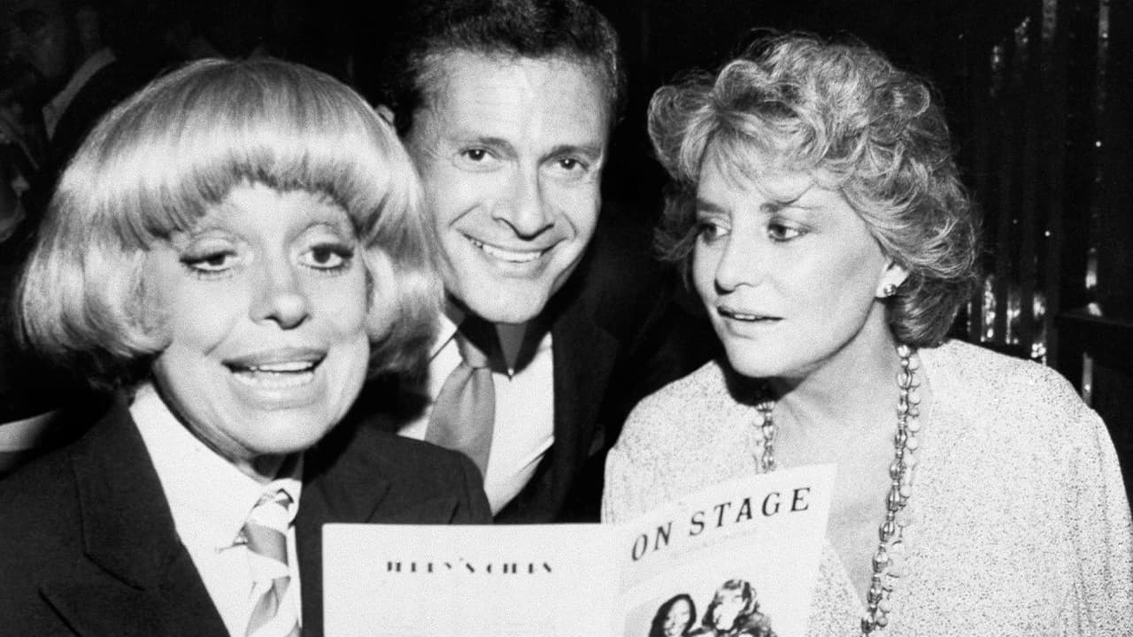Photo of Carole Channing, left, and television personality Barbara Walters looking over the program with composer-lyricist Jerry Herman