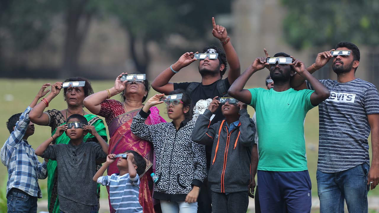 Photo of Indians watching the partial solar eclipse