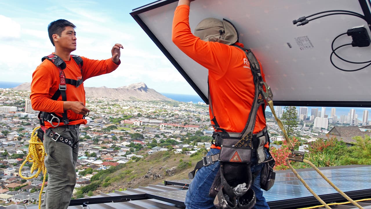 Photo of solar panel installers on a roof in Honolulu