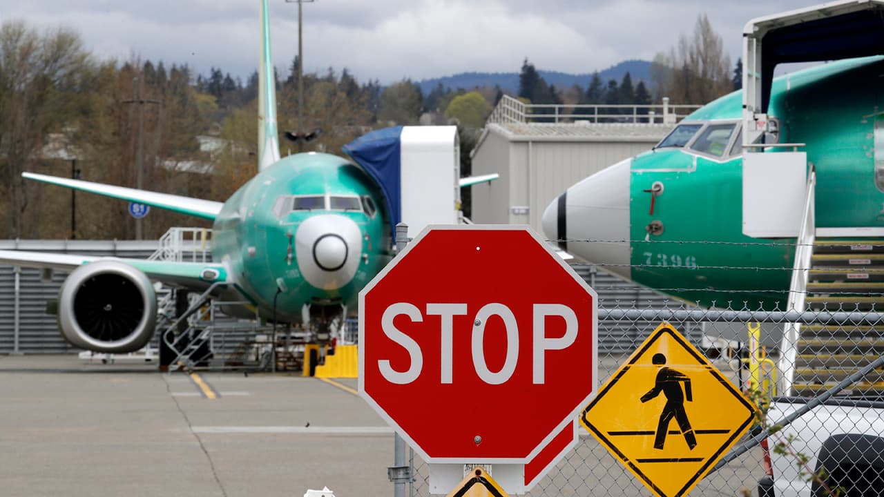 Photo of Boeing 737 MAX 8 jets are parked behind a stop sign
