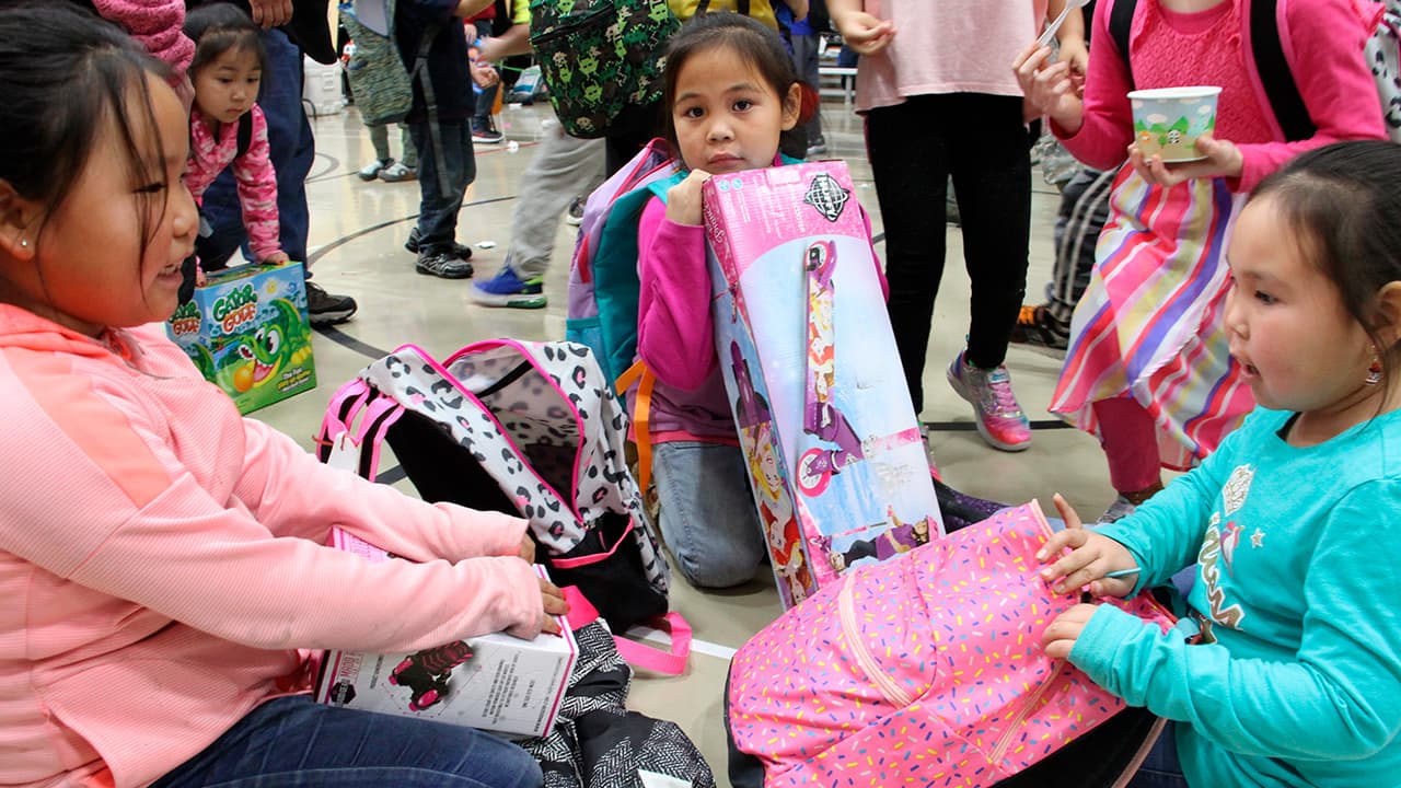 Photo of Krysta Lexie Kau'aq, left, Michelle Nelson, middle and Jessilyn Oscar, right admiring their gifts