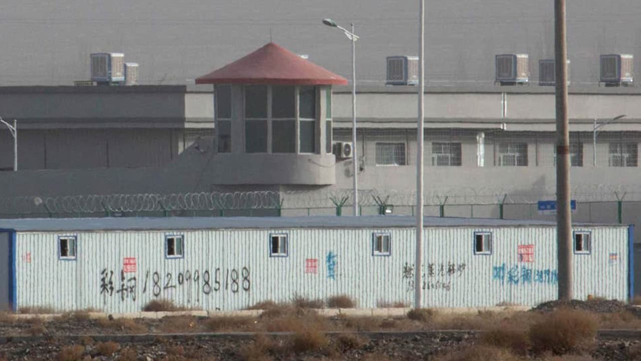 Photo of a guard tower and barbed wire fences are seen around a facility in the Kunshan Industrial Park in Artux in western China's Xinjiang region