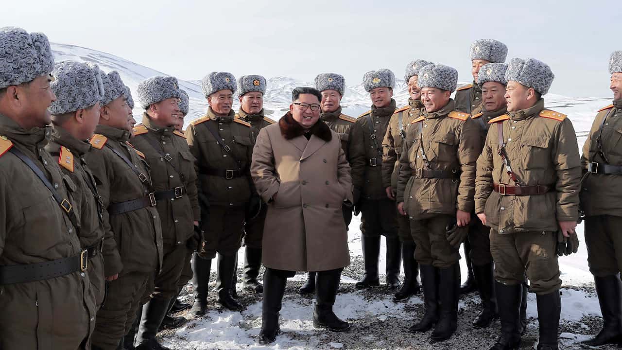 Photo of Kim Jong Un speaking to lieutenants