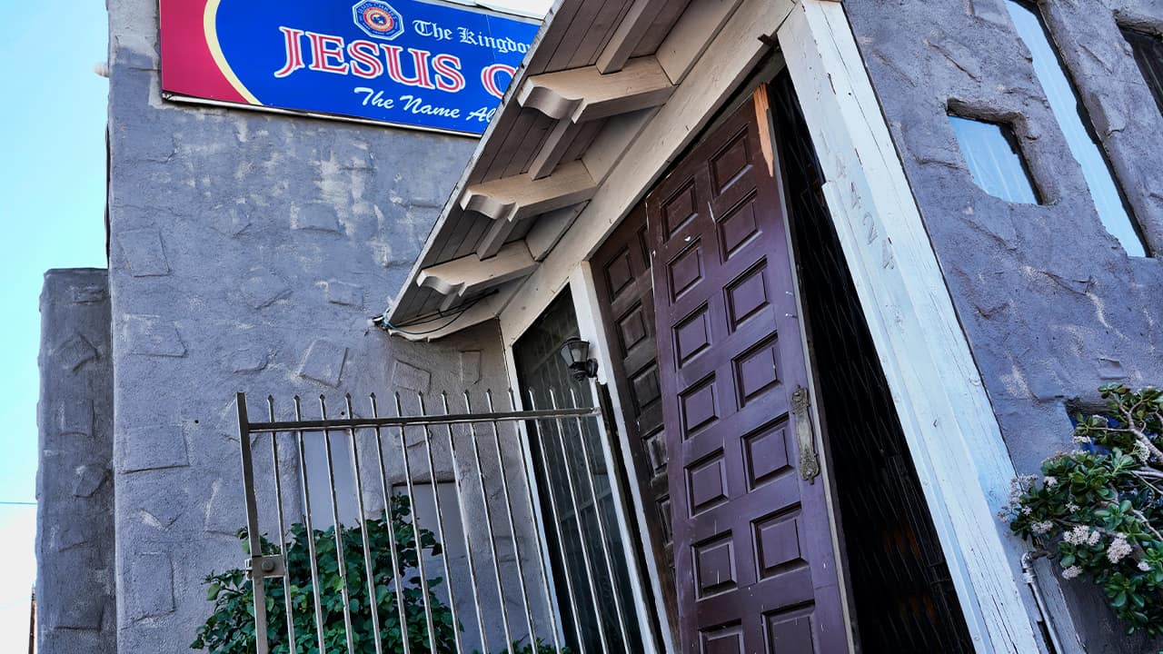 Photo of a smashed in door at the entrance of the Kingdom of Jesus Christ Church