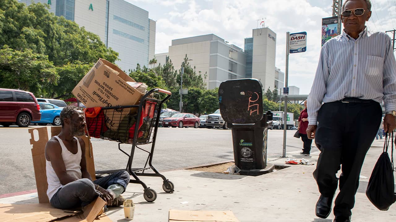 Photo of Will panhandling on the sidewalk