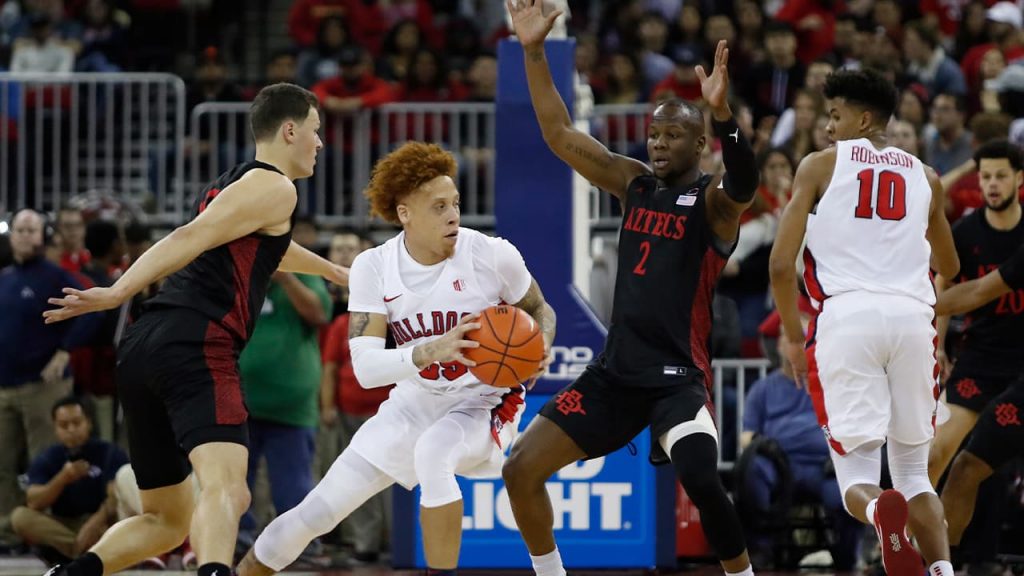 Photo of San Diego State players surrounding Fresno State's Noah Blackwell