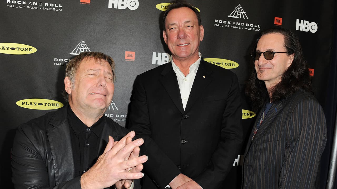 Photo of Alex Lifeson, Neil Peart, and Geddy Lee of Rush