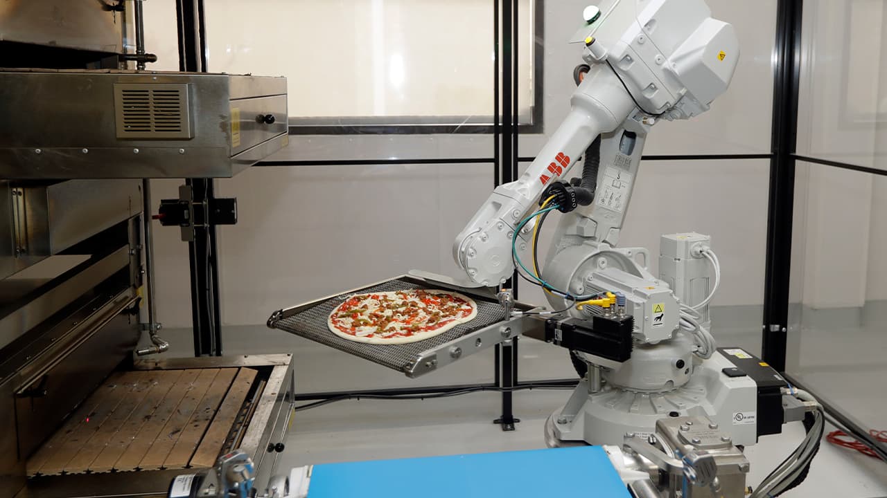 Photo of a pizza making robot