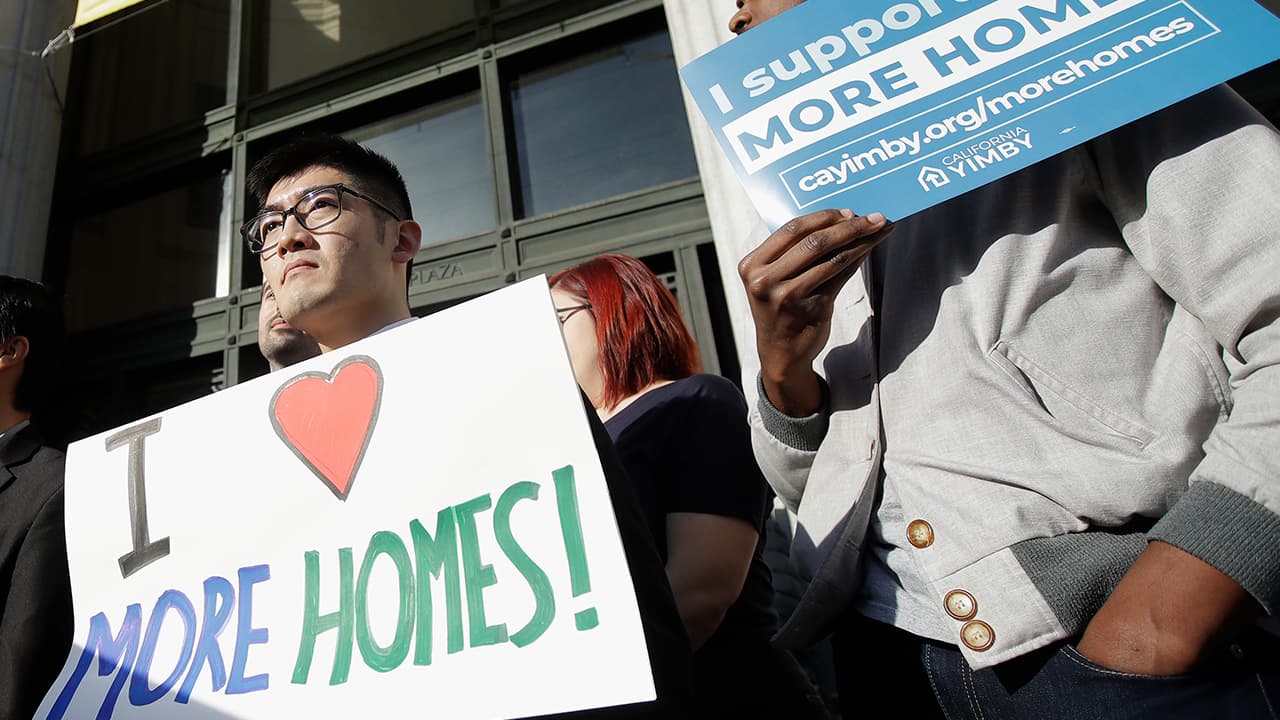 Photo of men holding up signs in Oakland