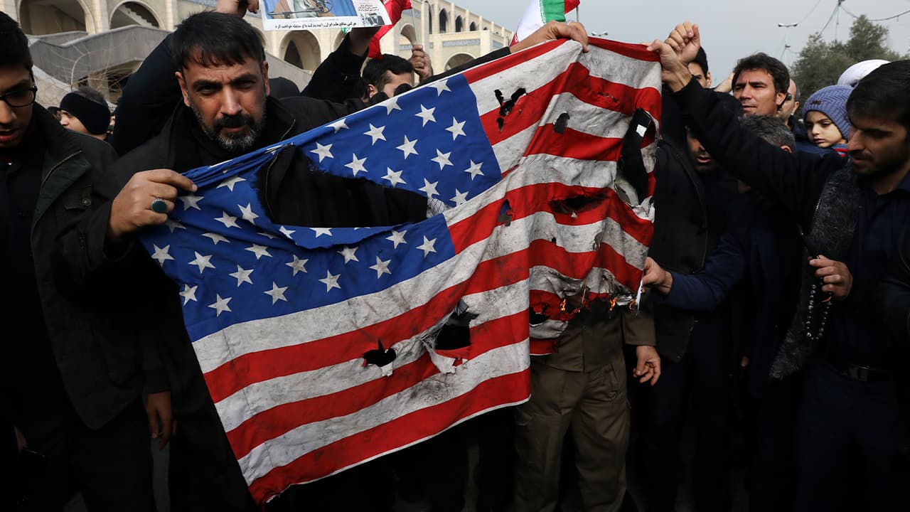 Photo of protesters burning an American flag