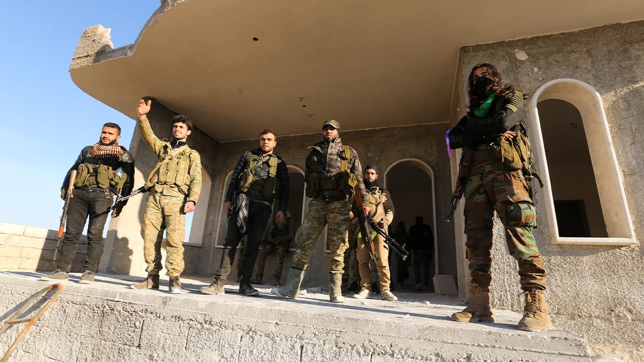 Photo of Syrian rebels entering the town of Saraqeb, in Idlib province, Syria
