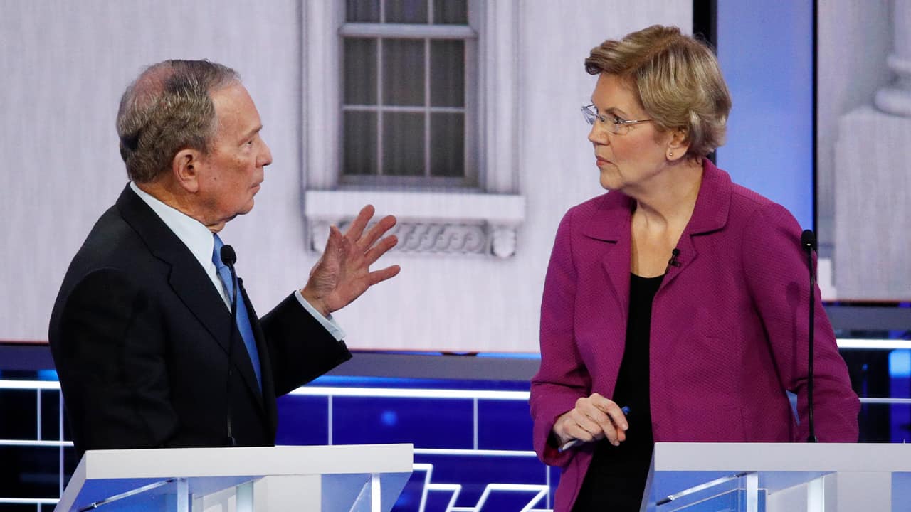Photo of Democratic presidential candidate, former New York City Mayor Mike Bloomberg talking with Sen. Elizabeth Warren