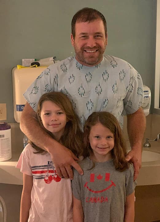 Photo of Ryan Newman with his daughters at the hospital