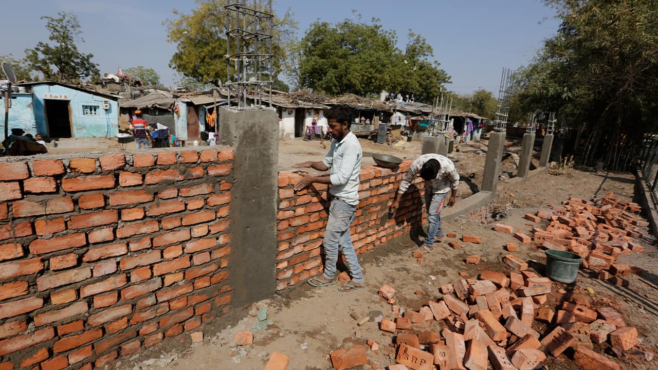 Photo of Indian workers constructing a wall