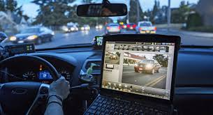 Photo of a patrol officer using a license plate reader camera