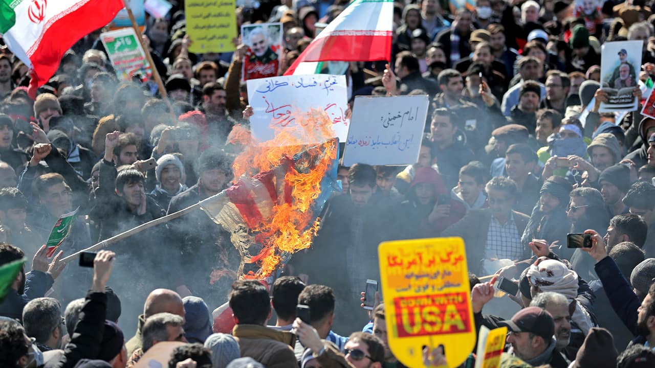 Photo of Iranians burning a U.S. flag during a rally