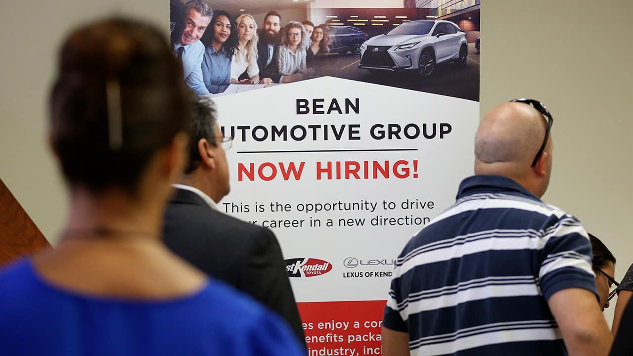 Photo of people standing in line to inquire about jobs