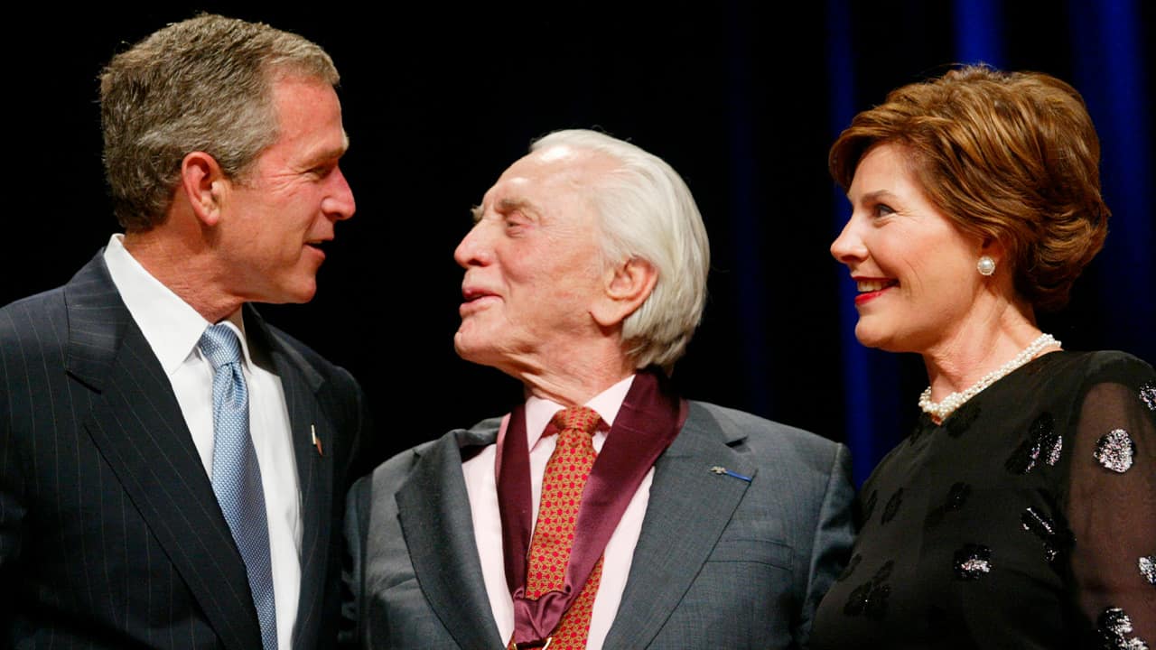 Photo of President Bush, left, with actor Kirk Douglas, center, and first lady Laura Bush, right