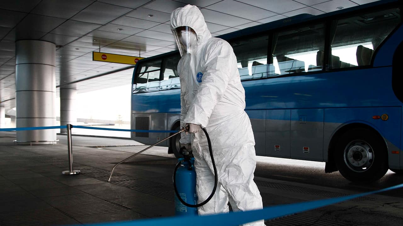 Photo of a worker disinfecting a ground transportation area in North Korea