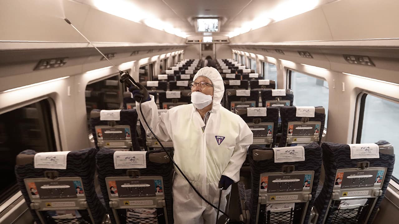 Photo of an employee spraying disinfectant on a train in South Korea