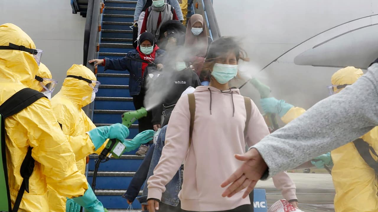 Photo of people being sprayed with antiseptic in Indonesia
