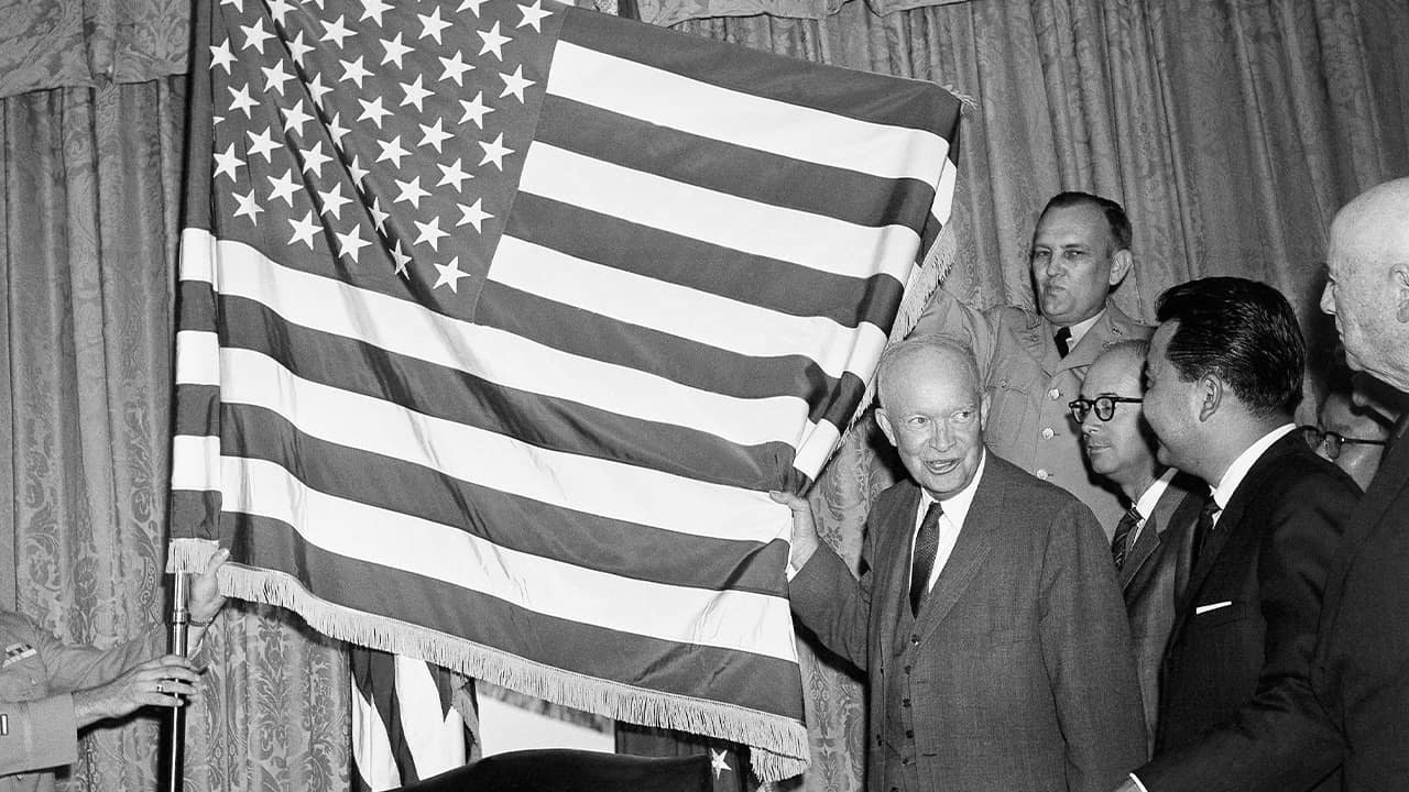 Photo of President Dwight Eisenhower with the new 50-star flag in Washington after signing a proclamation making Hawaii the 50th state of the union in 1959