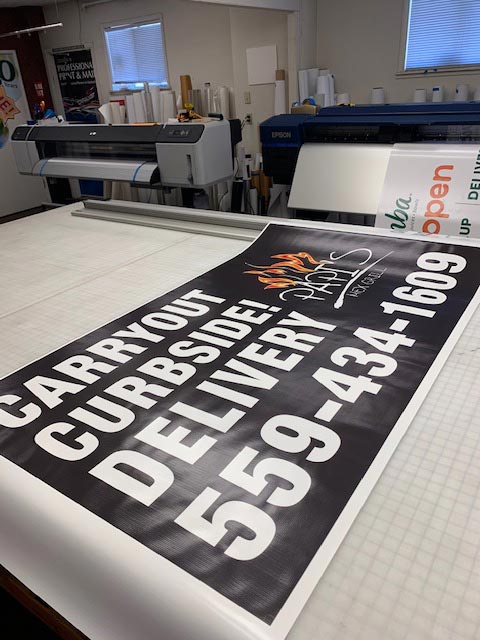 Photo of a banner being printed at Professional Print and Mail in Fresno, California