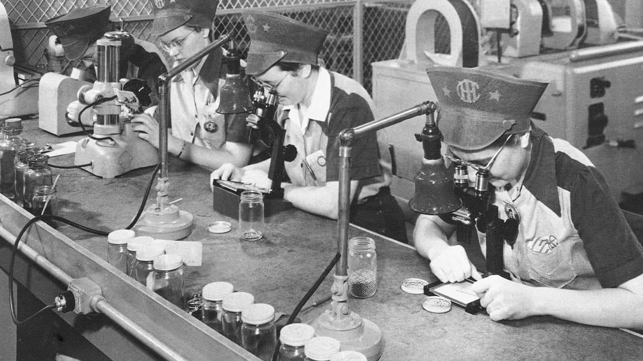 Photo of factory workers inspecting ball bearings in 1943